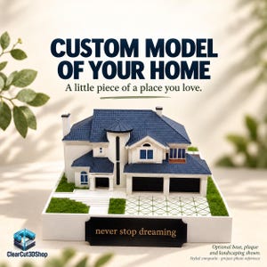 May include: A custom 3D model of a house with a dark blue roof and white walls, featuring a front driveway, green landscaping, and a black plaque at the base with the text "never stop dreaming" and the header "CUSTOM MODEL OF YOUR HOME".