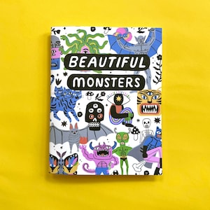 May include: A white book cover with the title "Beautiful Monsters" in black text. The cover features a colorful illustration of various monsters, including a cat, a skull, a bat, a tiger, a butterfly, and a snake.