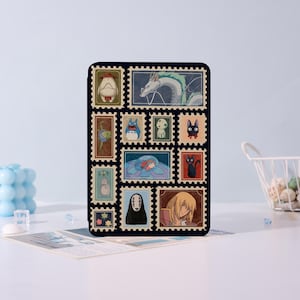 Puede incluir: Una funda rectangular negra con un collage de coloridos dise&ntilde;os de sellos postales. Los sellos representan varios personajes animados, incluyendo un drag&oacute;n, un gato y otras figuras caprichosas. La funda est&aacute; sobre un fondo azul claro.