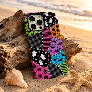 May include: A smartphone case featuring a patchwork design of Halloween-themed patterns including ghosts, jack-o'-lanterns, bats, stars, and stripes in vibrant colors like orange, purple, blue, pink, lime green, black, and gray.