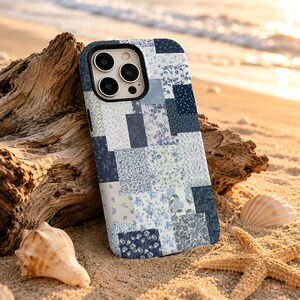 May include: A smartphone case featuring a patchwork design of various blue and white floral patterns. The case has a rectangular shape with rounded corners and a cutout for a triple-lens camera system on the upper left side of the back panel.