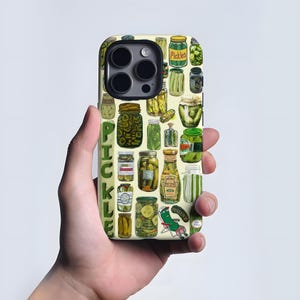 May include: A phone case with a design of assorted pickle jars, each with a unique shape and label. The word "PICKLE" is printed vertically in green. The background is a pale yellow.