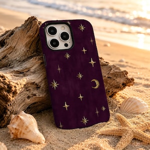 May include: A deep purple smartphone case featuring a scattered pattern of gold-colored four-pointed stars and a small crescent moon. The case has a rectangular cutout for the camera lenses and a smooth, matte-textured finish across the surface.