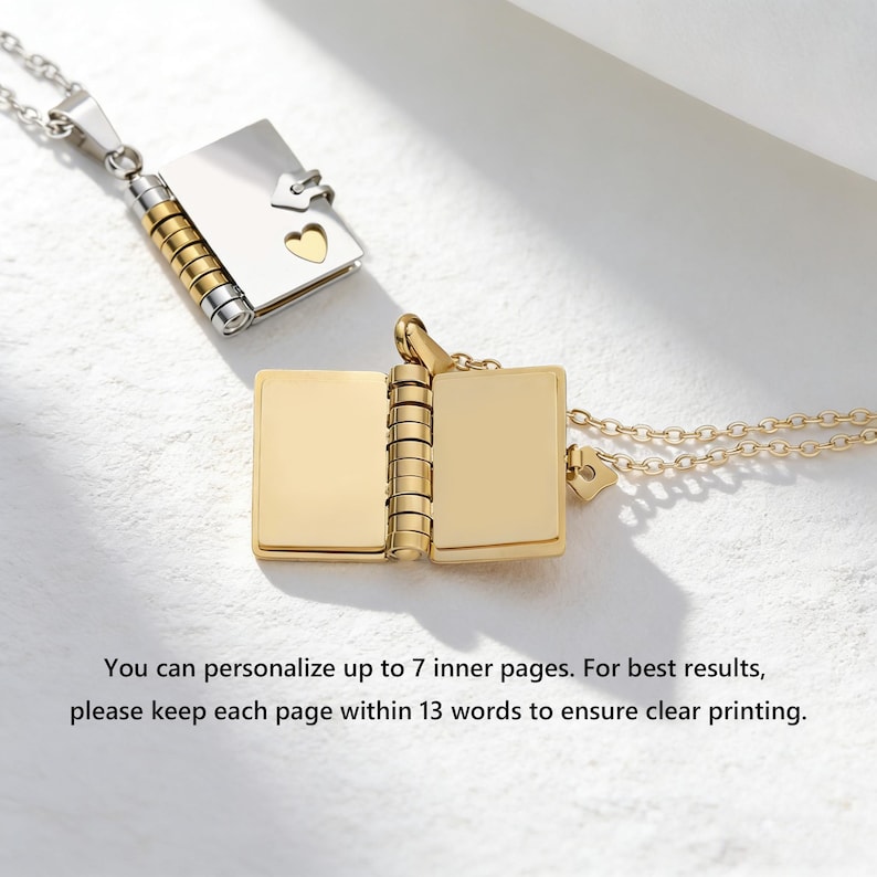 May include: Two open book-shaped pendant necklaces. One is gold-colored, the other silver with gold accents. The gold pendant is open, revealing blank pages. The silver pendant is closed, with a heart-shaped cutout. Text: You can personalize up to 7 inner pages.