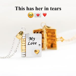 May include: A silver and gold locket necklace with the words "My Love" and a heart-shaped detail. The necklace has a silver chain and a gold clasp. The text "This has her in tears" is above the locket.