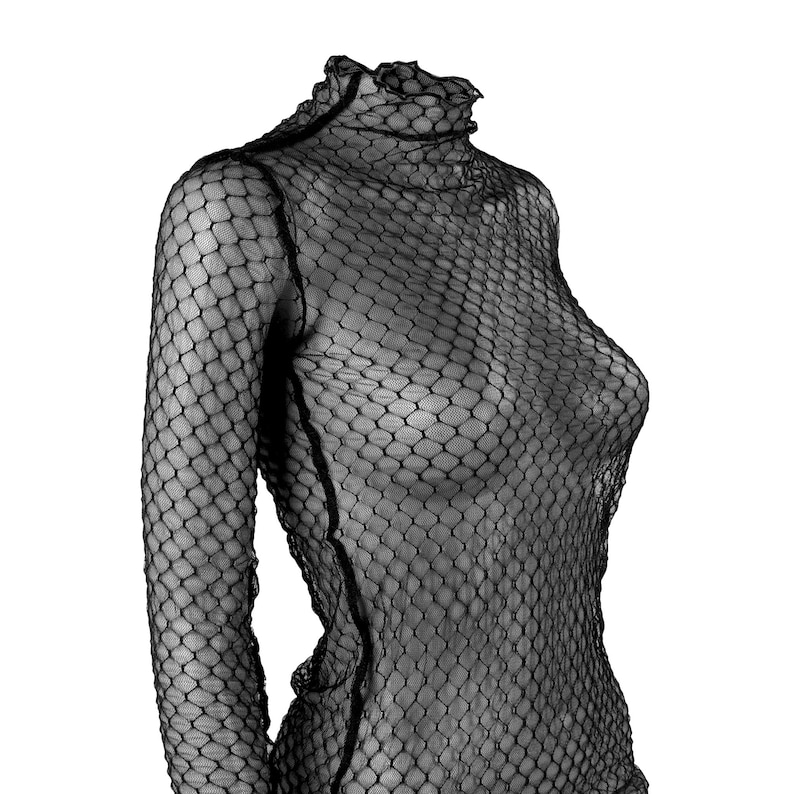 May include: A black, long-sleeved top with a high, ruffled neckline. The top is made of a fishnet-like material, creating a see-through effect. The garment is designed to be form-fitting.