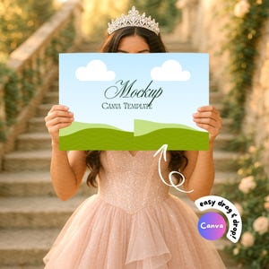 May include: A mockup template with a blue sky and green hills design, featuring the text "Mockup CANVA TEMPLATE". The template is held in front of a person wearing a tiara and a pink dress. The image also includes a "easy drag & drop! Canva" logo.