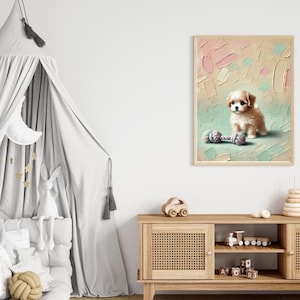 May include: A framed print featuring a fluffy, light brown puppy with dark eyes, sitting next to a colorful rope toy. The background has a textured, pastel color palette of pink, green, and beige.