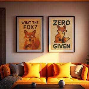 May include: Two framed art prints with fox illustrations hang above an orange sofa. One print reads "WHAT THE FOX?" and the other says "ZERO GIVEN." The sofa has orange pillows and a black coffee table.