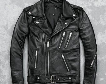 May include: A black leather motorcycle jacket with a classic asymmetrical zip closure. The jacket features multiple zippered pockets, a notched lapel collar, and a belt at the waist. Silver-toned hardware accents the jacket.