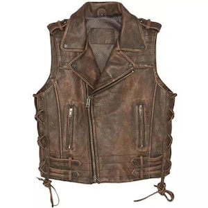 May include: Brown leather vest with a distressed finish, featuring a notched collar, a front zipper, and multiple zippered pockets. The vest has lace-up detailing on the sides and decorative buckles at the waist.