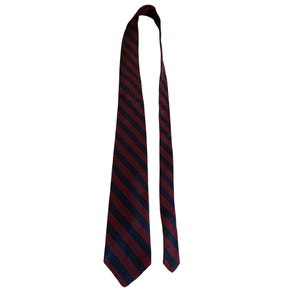 May include: A necktie featuring a repeating diagonal striped pattern in dark navy blue and deep burgundy red. The tie has a pointed end and a smooth, woven texture, displaying a classic design with consistent color bands running across the fabric.