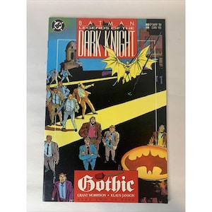 May include: A comic book cover for "Batman: Legends of the Dark Knight" features Batman in flight with a yellow cape. The cover has a dark background with the word "Gothic" and the Batman logo. The comic is issue number 7, from May 1990.
