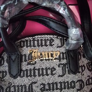 May include: A black and white handbag set with the text "Couture Juicy" in gold lettering. The bag has a black handle and the words "HANDBAG SET FOR MOM & HER MINI" are visible.