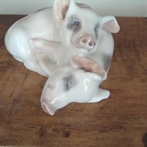 Royal Copenhagen porcelain figurine, specifically the &quot;Two Lying Pigs&quot; design Eryk Nielsen