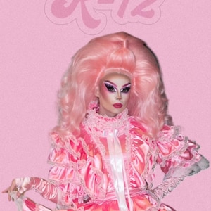 May include: A person wearing a pink dress with lace trim and a pink wig. The background is pink with the text "R-12" in a pink, cursive font.