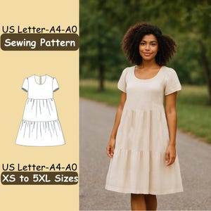 Pode incluir: Uma mulher vestindo um vestido bege em camadas com mangas curtas e decote redondo. O vestido vai até os joelhos. A imagem inclui um padrão de costura com o texto "US Letter-A4-A0 Sewing Pattern" e "XS to 5XL Sizes".