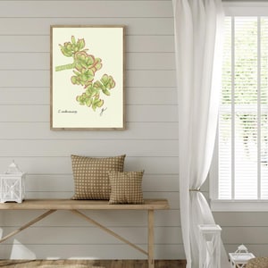 Jade print hanging on a wooden cabin wall above a bench with two brown pillows