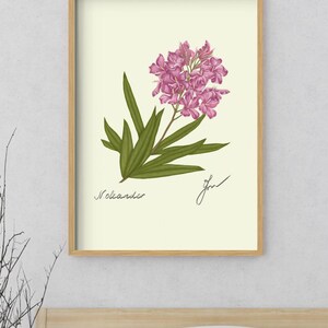 Oleander print in a wooden framed print above a bed