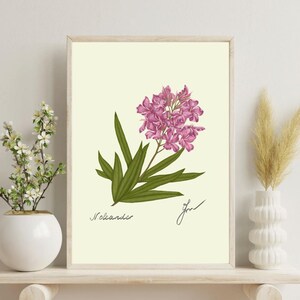 Oleander print on a white shelf next to two white vases and a white background
