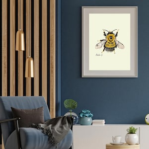 Bumblebee print in a white frame with passpartout hanging on a blue wall