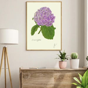 Hortensia print in a wooden frame hanging on a white wall