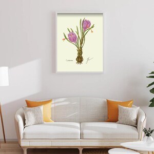 Crocus print in a white framed print on a white wall above a white couch