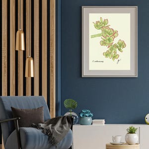 Jade print in a white frame with passpartout hanging on a blue wall