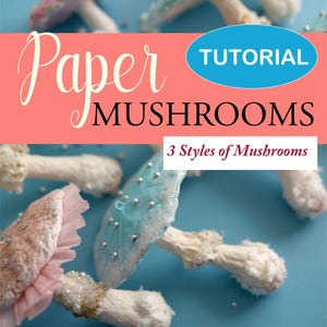 May include: An image featuring several handmade paper mushrooms in various styles. The mushrooms have white stems and colorful caps in shades of pink, blue, and white, decorated with glitter and beads. Text on the image reads "Paper Mushrooms" and "Tutorial".