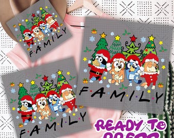 May include: Gray Christmas-themed design featuring cartoon dogs in Santa hats and outfits, with the word "FAMILY" below. The design is on a tote bag and a ready-to-press transfer.
