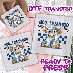 May include: DTF transfer sheets featuring a cartoon cow dressed as a ghost with the text "MOO...I MEAN BOO" and bats. The design includes blue and white checkered squares and the words "READY TO PRESS".