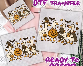 May include: DTF transfer sheets featuring a Halloween-themed design. The design includes cartoon geese dressed in witch hats, capes, and holding jack-o'-lanterns and coffee cups. A black cat is also featured. The words "READY TO PRESS" are visible.