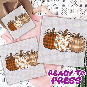 May include: Three pumpkin designs on a grid background. The pumpkins feature plaid, floral, and stitched patterns in orange, white, and brown. The phrase "READY TO PRESS" is in purple and white.