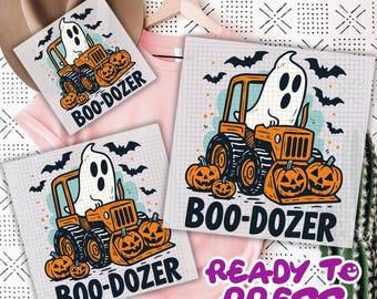 May include: Halloween-themed design featuring a ghost driving an orange bulldozer with jack-o'-lanterns. The text "BOO-DOZER" is below the image. Bats are flying in the background. The words "READY TO PRESS" are also visible.