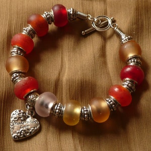 Glass Beads Bracelet colorful with Tibet Silver details and charm.
