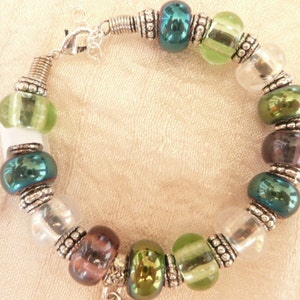 Glass beads bracelet ,multicolor ,with tibet silver detailes and charm.