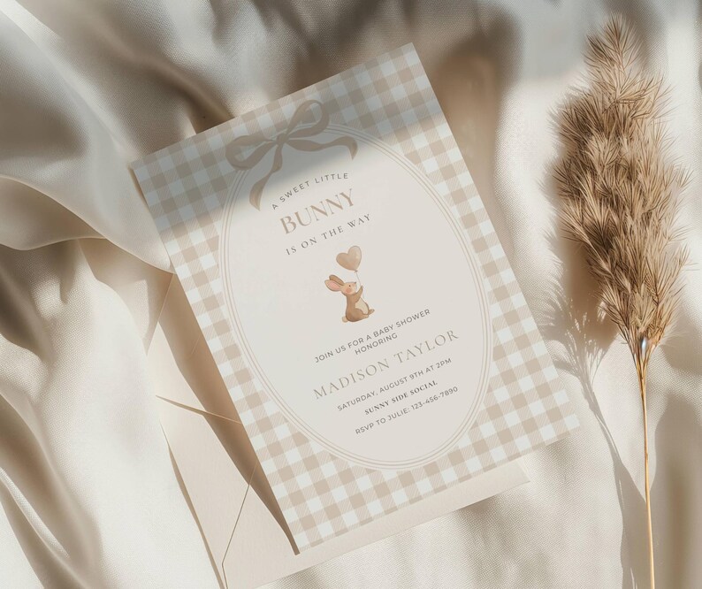 May include: A baby shower invitation with a gingham pattern in beige and white. The invitation features the text "A Sweet Little Bunny Is On The Way" and includes a cartoon bunny holding heart-shaped balloons. The invitation is for Madison Taylor.