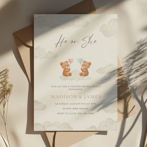 May include: Gender reveal party invitation with the text "He or She". The invitation features two teddy bears holding pink and blue heart balloons, set against a cloud background. Details include the names Madison & James, date, time, and RSVP information.