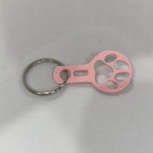 Brelok do kluczy z monetą w kształcie wózka sklepowego z nadrukiem łapy