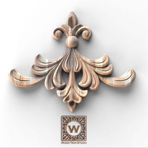 May include: A detailed, light-colored wooden decorative element with a symmetrical design. The central portion features a vertical, leaf-like pattern, flanked by curved, wing-like extensions. The design includes a small, square logo with the text "Wood Trim Studio".
