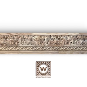 May include: A carved wooden moulding with a repeating floral and leaf design. The moulding is light brown and features detailed carvings. The Wood Trim Studio logo is in the bottom right corner.