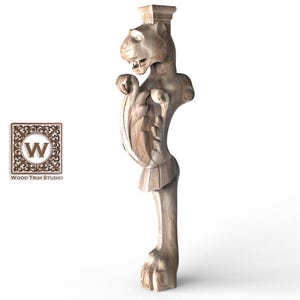 May include: A carved wooden furniture leg with a lion's head and paw design. The leg is light brown and features intricate details, including a decorative shield and scrollwork. The Wood Trim Studio logo is visible.