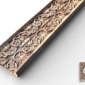 May include: A wooden trim moulding with an intricate carved design featuring floral patterns and swirls. The moulding is light brown in colour and has a smooth, polished finish.