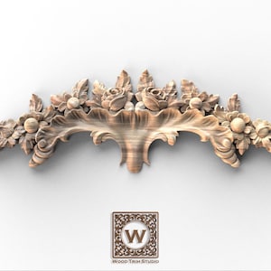 May include: A carved wooden floral decorative element featuring roses, leaves, and other floral details. The piece is light brown and has a curved shape. The logo for Wood Trim Studio is in the lower center.
