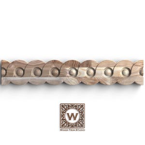 May include: A decorative wooden trim piece with a repeating circular pattern. The trim is made of light-colored wood and features a series of interlocking circles with a scalloped edge. The Wood Trim Studio logo is in the bottom right corner.