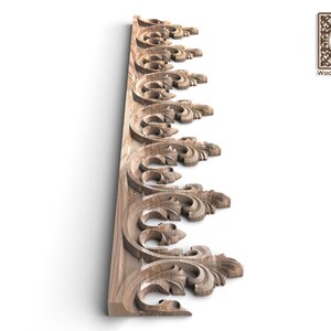 a decorative wooden panel with intricate scrollwork and floral patterns.