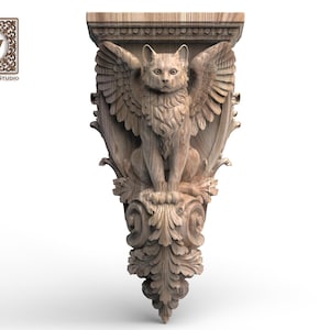 May include: A light brown wooden corbel featuring a carved winged cat figure centered above ornate acanthus leaf scrollwork. The top section has a flat rectangular surface with a beaded edge. A logo with the text Wood Trim Studio is visible.