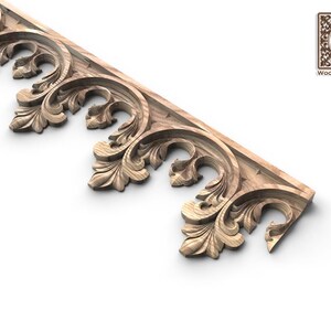 a decorative wooden piece with intricate carvings, including leaves and floral patterns, showcasing the craftsmanship and artistry of the piece.