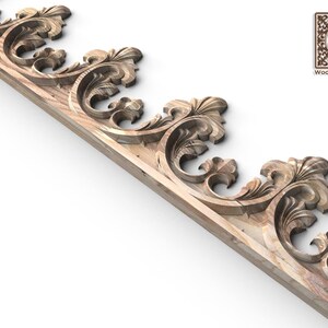 a decorative wooden panel with intricate scrollwork and floral designs.