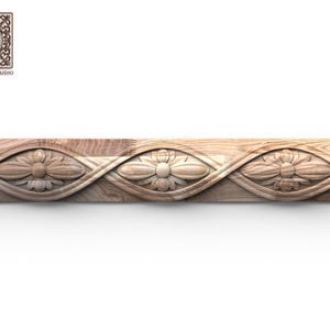 May include: A carved wooden trim piece featuring a repeating floral pattern. The design incorporates stylized flowers within a woven, flowing border. The wood has a natural grain and a light brown color, with the logo "Wood Trim Studio" in the upper left corner.